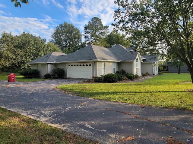 view of front of property with a garage, stucco siding, a front lawn, driveway, and roof with shingles