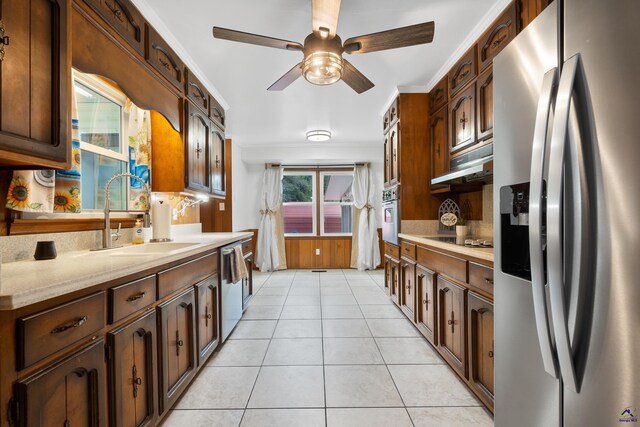 kitchen featuring light tile patterned flooring, sink, stainless steel appliances, crown molding, and decorative backsplash