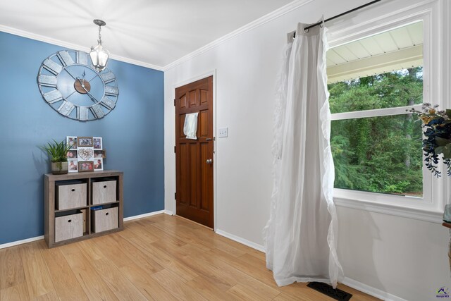 foyer featuring light hardwood / wood-style flooring and ornamental molding