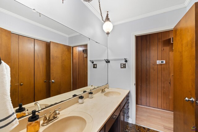 bathroom with hardwood / wood-style flooring, vanity, and crown molding