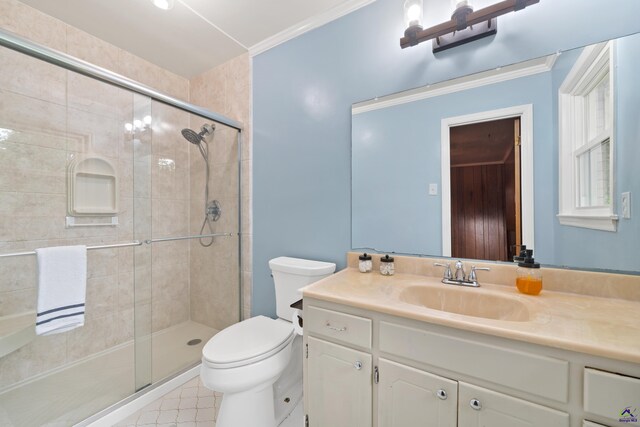 bathroom featuring ornamental molding, an enclosed shower, vanity, and toilet