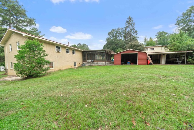 view of yard with an outdoor structure and a sunroom