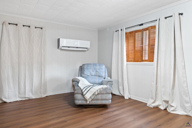 sitting room featuring ornamental molding, dark hardwood / wood-style flooring, and a wall mounted air conditioner