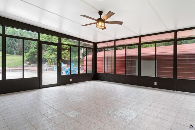 unfurnished sunroom featuring ceiling fan