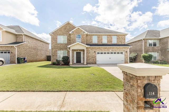 view of front of property featuring a front yard and a garage