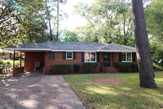 single story home with concrete driveway, a front lawn, brick siding, and a carport