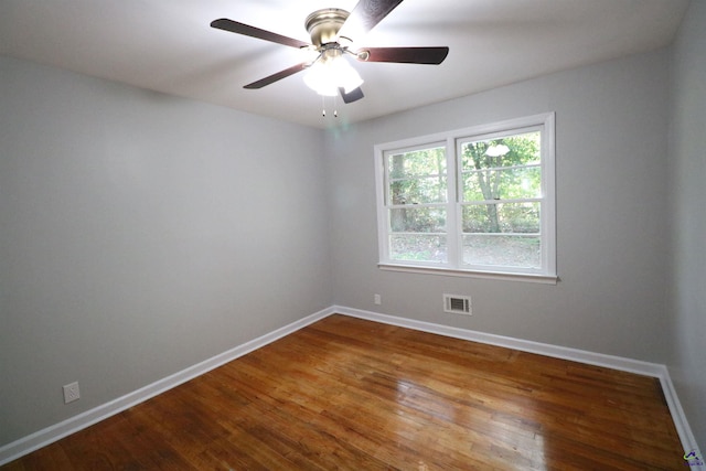 unfurnished room with baseboards, wood finished floors, and ceiling fan