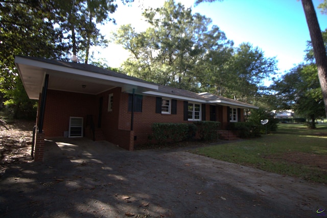 single story home with brick siding, driveway, crawl space, and an attached carport