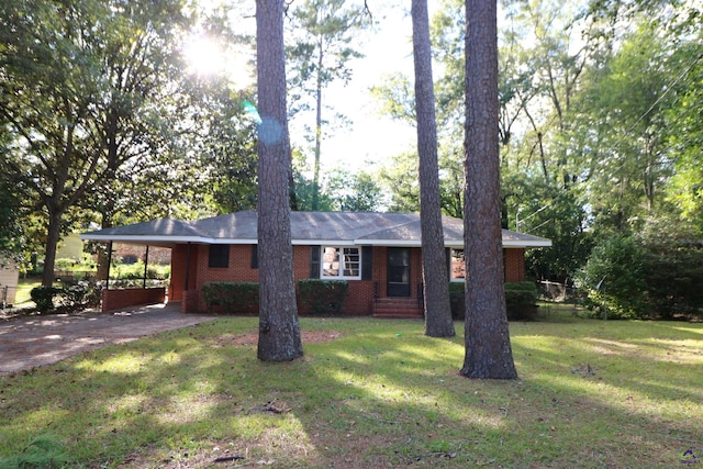 ranch-style house with asphalt driveway, brick siding, a carport, and a front lawn