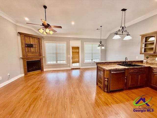 kitchen featuring dishwasher, light hardwood / wood-style floors, tasteful backsplash, ceiling fan with notable chandelier, and hanging light fixtures