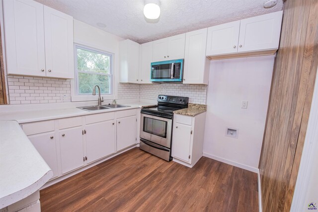 kitchen featuring stainless steel appliances, white cabinets, and sink