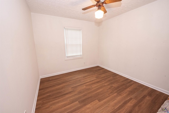 unfurnished room with ceiling fan, a textured ceiling, and dark hardwood / wood-style floors