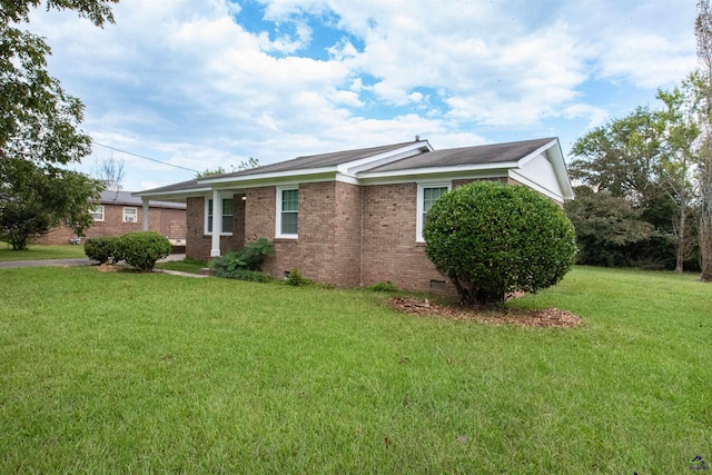 view of side of home with a yard