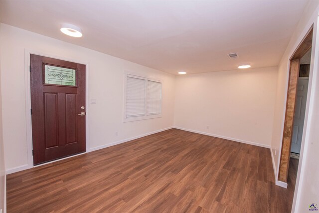 entryway with dark hardwood / wood-style flooring