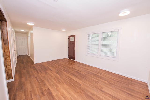 spare room featuring dark wood-type flooring