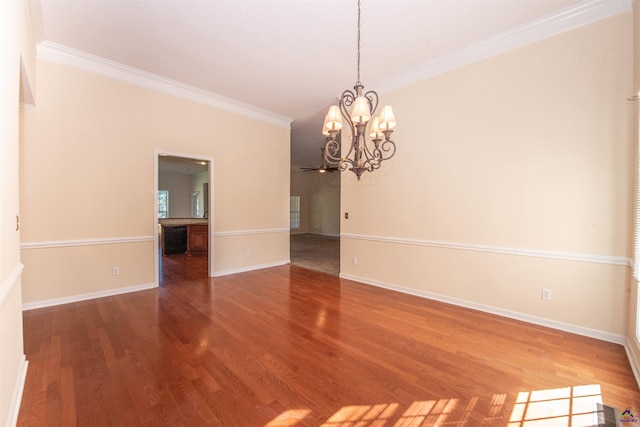 unfurnished room with wood-type flooring, crown molding, and a notable chandelier