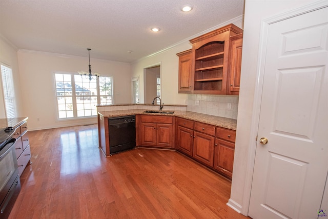 kitchen featuring light hardwood / wood-style floors, sink, kitchen peninsula, and black dishwasher