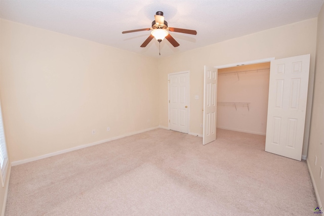 unfurnished bedroom with ceiling fan, a closet, and light colored carpet