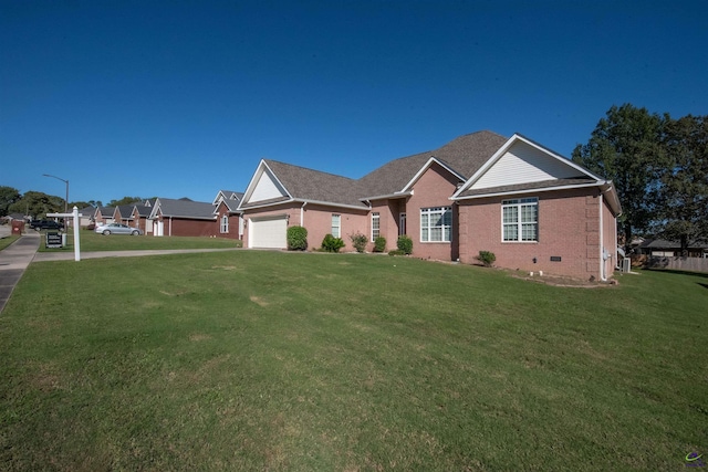 view of front of property with a front yard and a garage