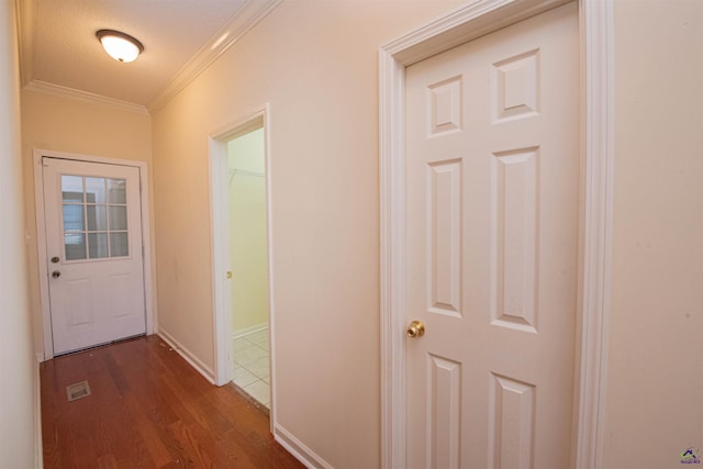 hallway with crown molding, dark hardwood / wood-style flooring, and a textured ceiling