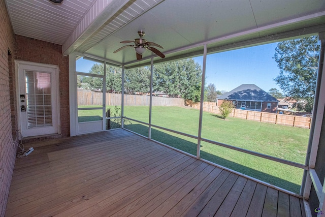 unfurnished sunroom featuring ceiling fan