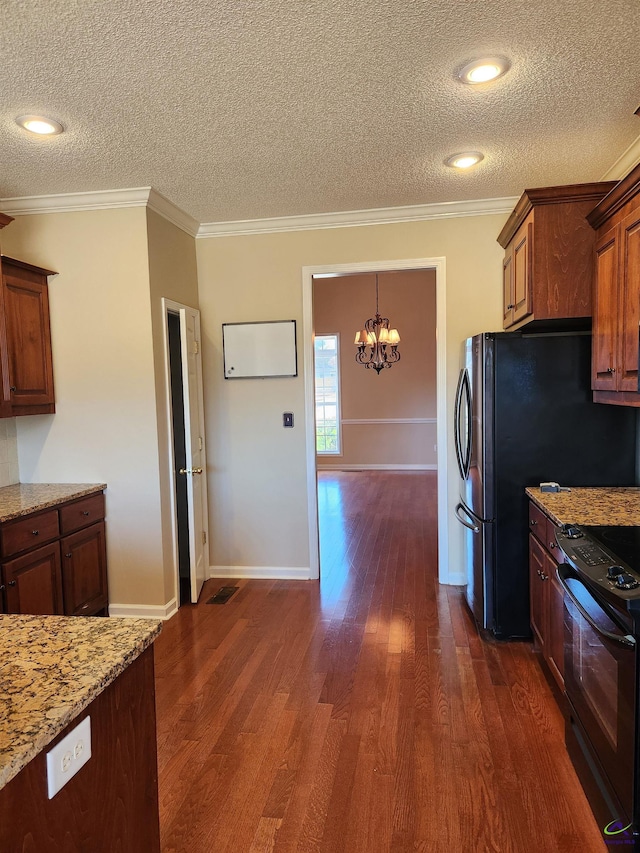 kitchen featuring a textured ceiling, dark hardwood / wood-style flooring, black electric range oven, and ornamental molding