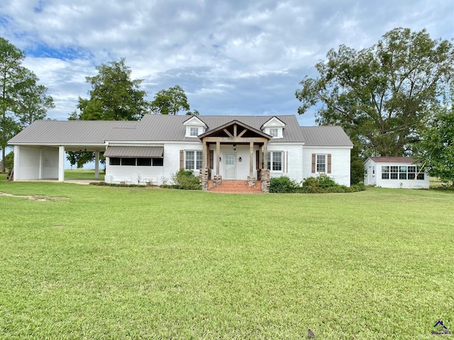 view of front of house with a carport and a front lawn