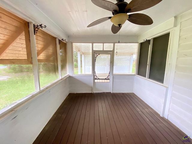 unfurnished sunroom with ceiling fan