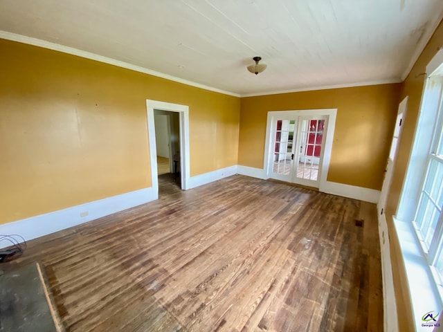 spare room featuring wood-type flooring, french doors, and ornamental molding