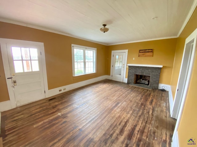 unfurnished living room featuring a brick fireplace, crown molding, and dark hardwood / wood-style flooring