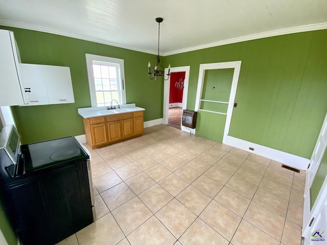 bathroom with sink, heating unit, an inviting chandelier, crown molding, and tile patterned flooring