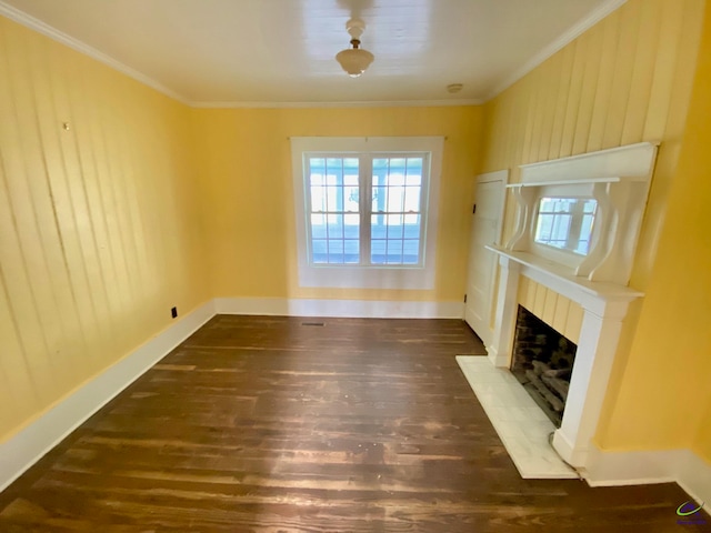 unfurnished living room with crown molding, a fireplace, and dark hardwood / wood-style flooring