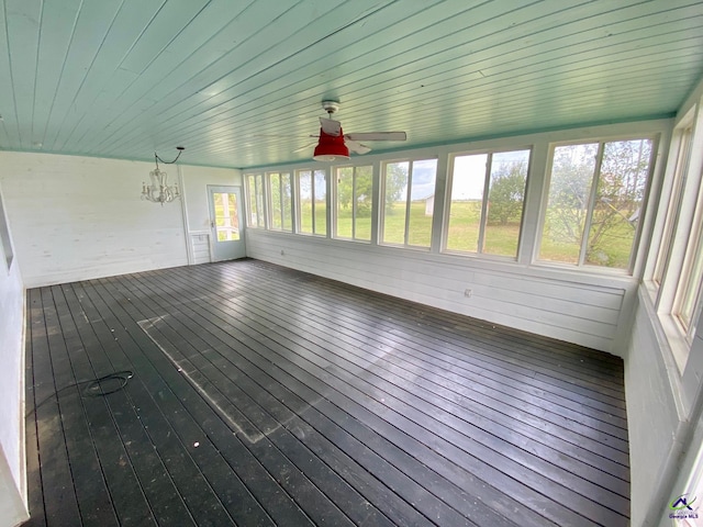 unfurnished sunroom featuring ceiling fan with notable chandelier and wooden ceiling