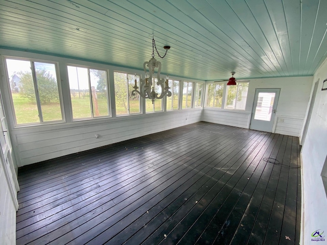 unfurnished sunroom featuring wood ceiling and a chandelier