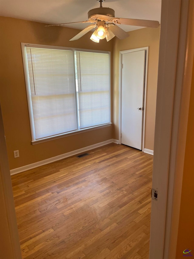 spare room featuring ceiling fan and light hardwood / wood-style flooring