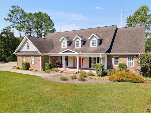 cape cod-style house with a front lawn