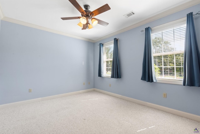 carpeted empty room with ceiling fan, ornamental molding, and a healthy amount of sunlight