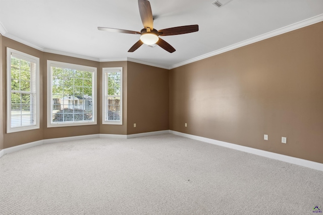 carpeted spare room with ornamental molding and ceiling fan