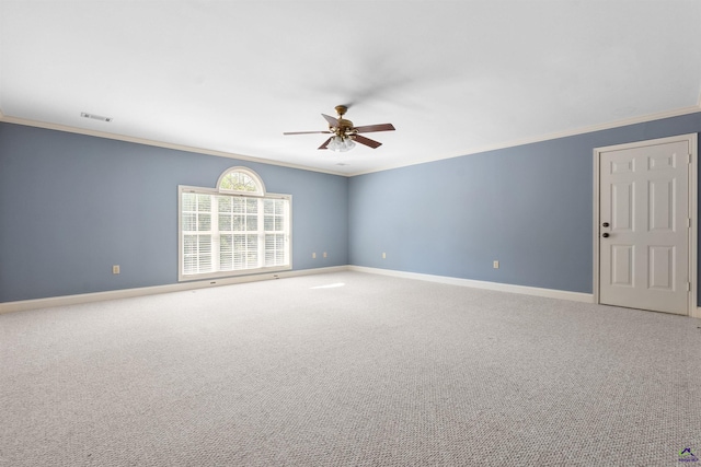 empty room with ceiling fan, crown molding, and carpet