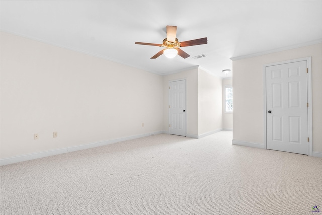 unfurnished bedroom featuring light carpet, crown molding, and ceiling fan