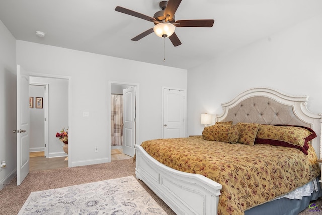 bedroom featuring ceiling fan, carpet floors, and ensuite bathroom