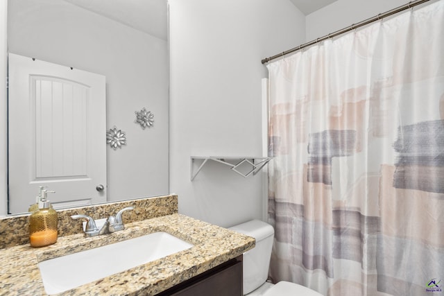 bathroom featuring vanity, toilet, and a shower with shower curtain