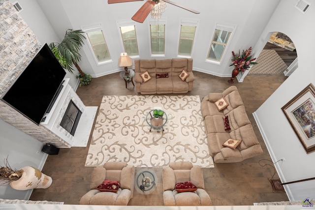 living room with a towering ceiling and ceiling fan