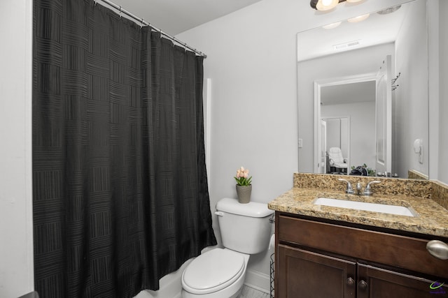 bathroom with vanity, toilet, and curtained shower