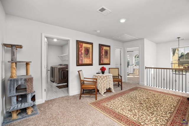 dining space with light colored carpet and washer and clothes dryer