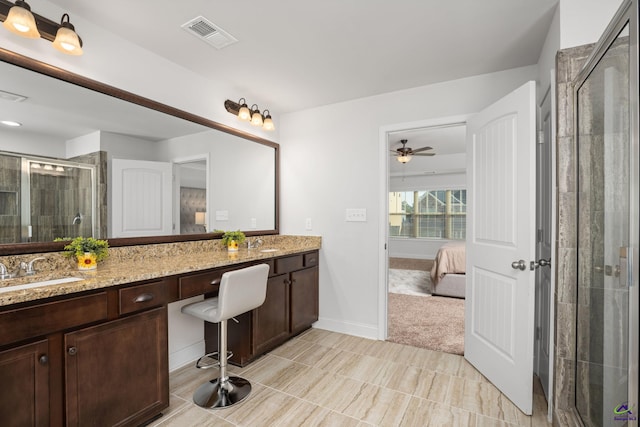 bathroom with ceiling fan, vanity, and a shower with shower door