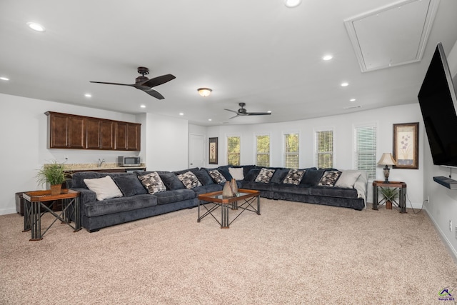 living room with ceiling fan and light colored carpet