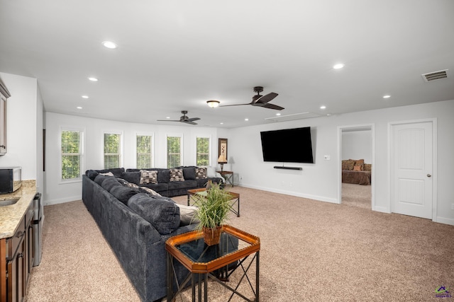 living room with ceiling fan and light colored carpet