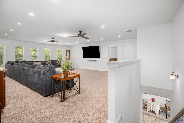 carpeted living room featuring ceiling fan