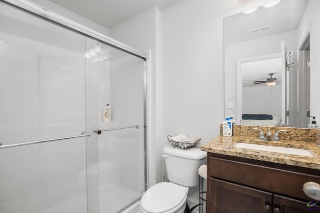 bathroom with an enclosed shower, ceiling fan, vanity, and toilet